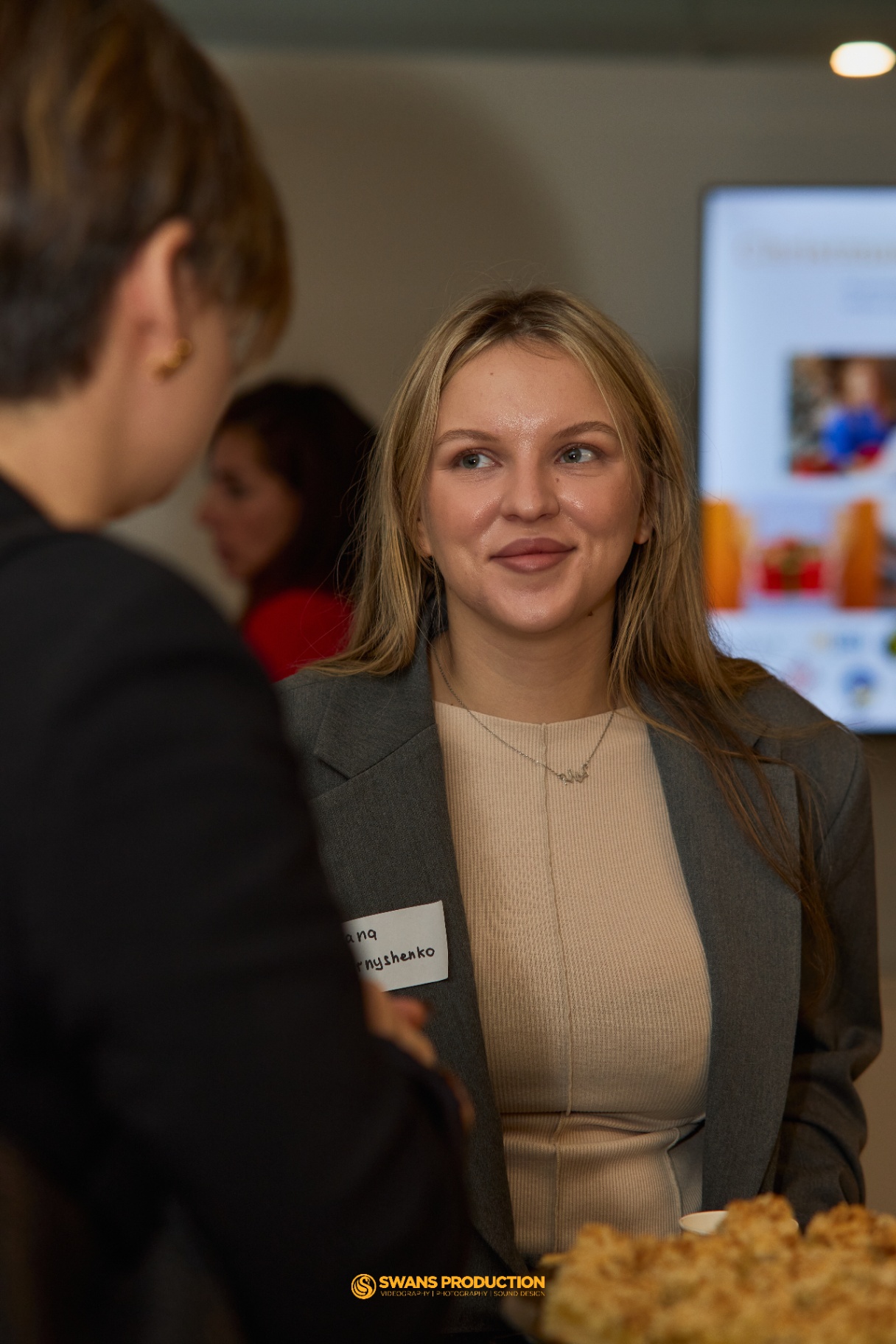 Two guests in conversation during the Christmas Magic for Kids in Ukraine charity event