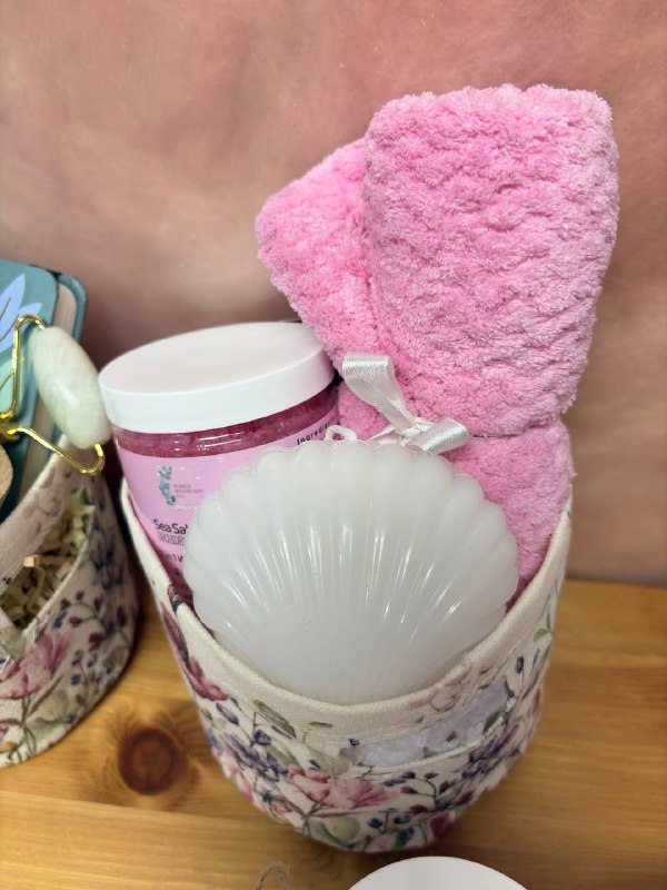 Phone photo of a pink towel and bath products in a basket